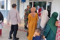Personel Polres Lhokseumawe Amankan Penyaluran Bantuan Pangan