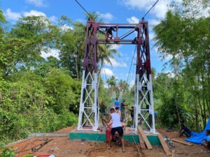 IMG-20260325-WA0044-300x225 Kodim 0213/Nias Bersama Yonif TP 903/BS Rampungkan Jembatan Gantung di Desa Ononamolo III. 