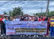 Warga Dusun XVIII Persil berfoto bersama dengan memegang spanduk ucapan terima kasih untuk menyambut penuh sukacita rampungnya pengaspalan Jalan Persil. (Dok. Diskominfostan Deli Serdang)